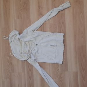 Off white, thin, zip-up, small, define body, hooded, lightweight, with pockets.